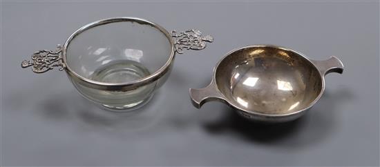 An Indian white metal quaich by Cooke & Kelvey, and a white metal mounted glass quaich(a.f.), largest 15.5cm.